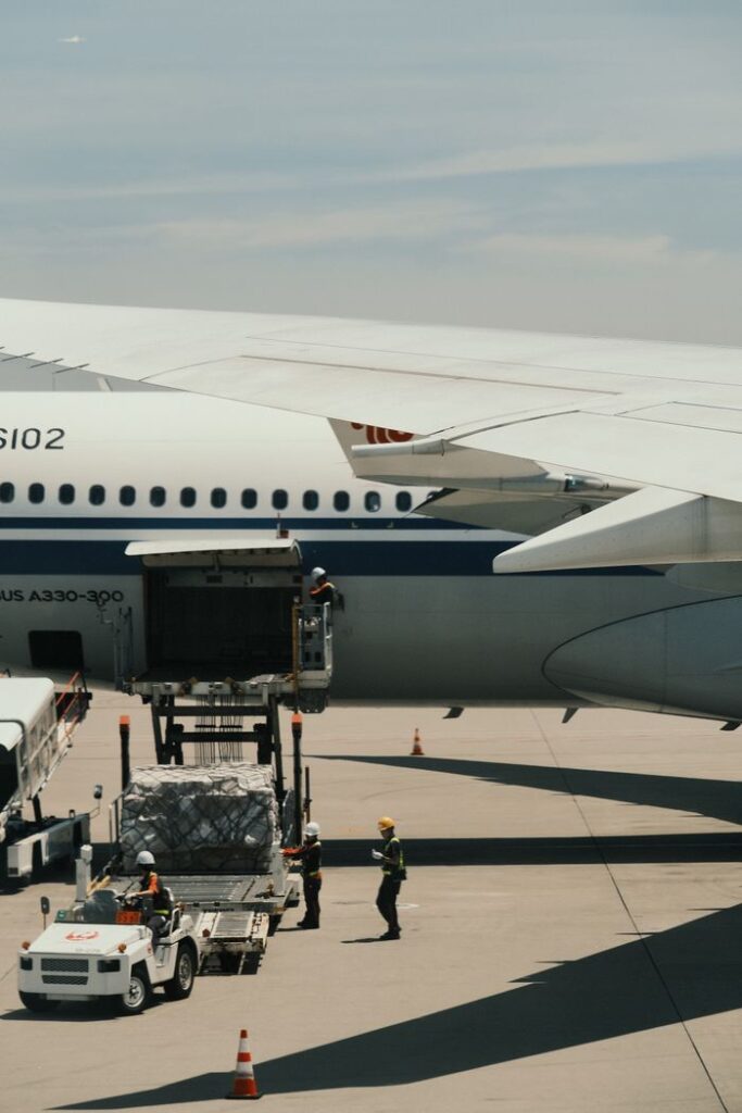 pexels-photo-27490332-27490332 Airbus A330 being loaded with cargo on an airport runway, showcasing transportation logistics.