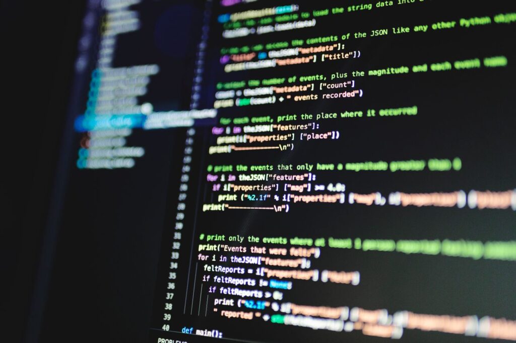 pexels-photo-6424583-6424583 Close-up of colorful programming code displayed on a computer monitor with a dark background.